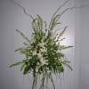 The focal flowers are fragrant white lilies surrounded with smaller white linear