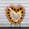 A grand heart-shaped easel spray for the memorial of a loved one.