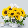 Large spring sunflowers with hydrangeas in a handcrafted basket. Finished with ivory
