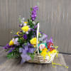 Large basket with assorted fresh flowers and a variety of sweet and