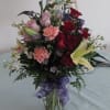 A beautiful arrangement of roses, lilies, carnations and various greens. Show that