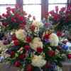 Red Roses, White Hydrangea, Blue Delphinium, Seeded Eucalyptus and assorted foliage for