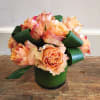 Dozen roses with a modern twist! Low and compact with a leaf