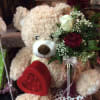 Teddy Bear adorned with a heart box of assorted chocolates and s