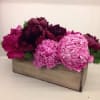 A pretty arrangement including pink and dark red peonies.