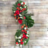CONTEMPORARY NATURAL FUNERAL CROSS ON A EASEL.
