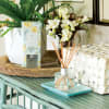 Freesia bouquets and delicate white tea flutter into citrus accords of tangerine