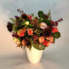 large lush arrangement of seasonal blooms. Perfect for entrance table or buffet
