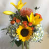 Mixed of sunflowers, lilies, hydrangeas, spray roses, and protea. 