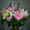 Pink roses, gerberas, and other flowers with a touch of white artfully