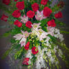 easel spray for the service.  Red roses, white lilies, and white