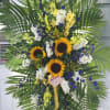 Sunflowers, yellow gladiolus, white stock, blue delphiniums,  finished with premium greens.