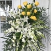 Yellow roses, white orchids, white Lily&#039;s and white stock. Finished with premium