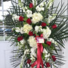 White hydrangea, red roses, white snap dragon, white stock, finished with premium