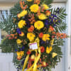 Yellow gerbera daisies, yellow/orange roses, dark blue delphiniums, peach hypericum berries, orange