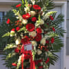 White snap dragon, red gerbera daisies, red roses, red hypericum berries, white
