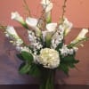 White premium calla lilies, white hydrangeas, white dendrobium orchids. Finished with curly