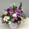 Lovely arrangement of lavenders and whites in a white basket