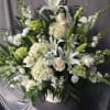A mixture of white hydrangea, white stock, white roses, white lisianthus, white