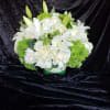 Elegant and solemn, the Best Wishes arrangement is a fitting addition to
