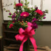 This beautiful vase arrangement includes hot pink gerbera daisy, hot pink carnations