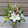 Butterflies flutter around this elegant design.  Lillies, Calla lilies, Larkspur, stock