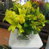 This contemporary cubes has assiatic lillies,alstomeria, yellow roses and assorted greens. 