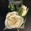 White rose boutonniere on silver aluminum backing.  Perfect for formal or
