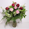 A dozen beautiful roses with luscious flowers in a nice vase to