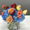 A cute showstopper. Bright multicolored roses make this darling arrangement pop. Perfect