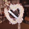 All white carnations with roses and greenery and a touch of love