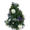 This boxwood tree includes delphinium, baby&#039;s breath, white roses, silver ornament and