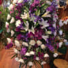 This large spray arrangement features white lilies and spider mums and is
