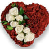 The sweet bouquet includes white spray roses surrounded by red miniature carnations
