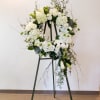Send a beautiful white floral wreath to show your sympathy to a