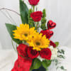 This Valentines Day arrangmnet consists of red rose, sunflowers, and is topped