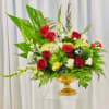 A cheery floral design consisting of roses, snapdragon, thistle, mums, and greenery.