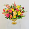 Golden tones highlighted with hot pink accents. Flowers consist of asiatic lilies