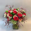 loose garden design in modern angular vase assorted blooms of roses, carnations