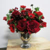Lush traditional with red garden roses, anemones and ranunculas; whimsical and playful.