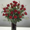 3 dozen long-stemmed red roses arranged in a tall red and clear