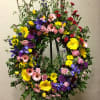 Standing wreath including all fresh flowers: iris, gerbera, rose, carnation, pompon... and
