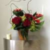 Red Roses, cymbidiums and more in a beautifully arranged square box vase.