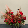 Arrangement with pampas grass, tulips, cymbidium orchids, roses, and different fillers to