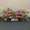 Different shades of lavender roses accompanied by pampa grass, silver dollar, lisianthus