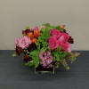 Medium arrangement with hot pink roses, orange tulips, sprayed roses, hydranyas and