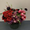 Beautiful arrangement in an 8x8in vase with red roses, pink tulips, vanda