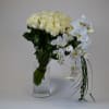 Amazing vase made with a bundle of white lovely roses and phalaenopsis
