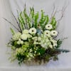 Cream and green florals in a beautiful basket is a gift of