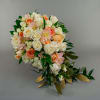 A cascading bridal bouquet of cream roses, white spray roses, peach roses